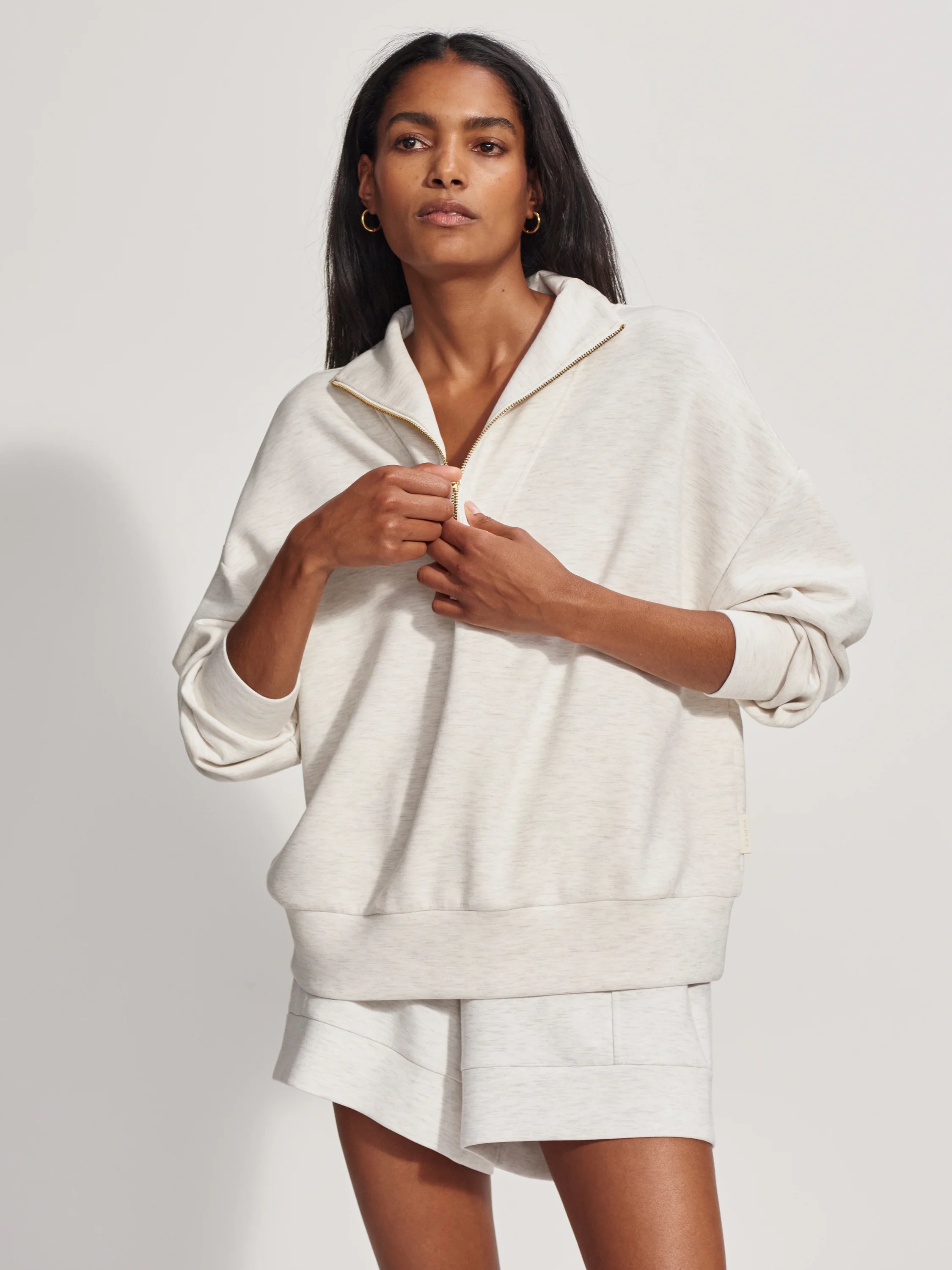 Off-white half-zip sweatshirt with a slightly relaxed fit and gold zipper.  Features a small logo tag.