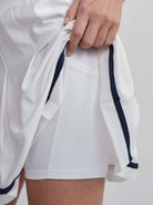 White skort with navy blue side stripes and inner shorts.  Features a built-in pocket.