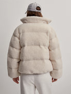 Off-white sherpa puffer jacket.  The jacket is shown from the back.  It has a high collar and quilted design.