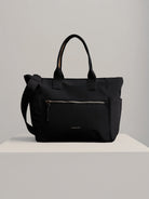 Black crossbody bag with top handles & shoulder strap; silver zipper & subtle branding.