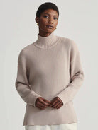 Light beige ribbed mock neck sweater.  Long sleeves, relaxed fit.