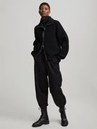 Black ribbed mock neck knit sweater with silver full zip-front.