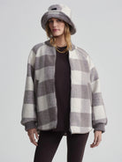 Taupe grey and cream large check quilt bomber jacket. Features ribbed cuffs, collar, and hem, with a silver front zipper.