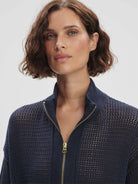 Navy blue half-zip knit sweater with a mesh body, ribbed collar, and gold zipper.
