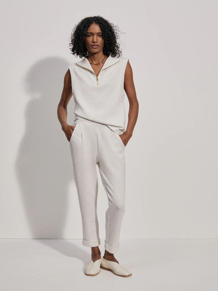 Off-white rolled-cuff pants on a model.  The pants are a textured off-white fabric.