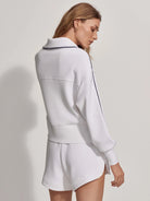 White half-zip sweatshirt with navy blue trim.  Features long sleeves and a fitted waist.