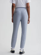 Here's alt text under 125 characters:

"Light blue heather knit slim-fit pants, seen from the back.  Elastic waistband,...