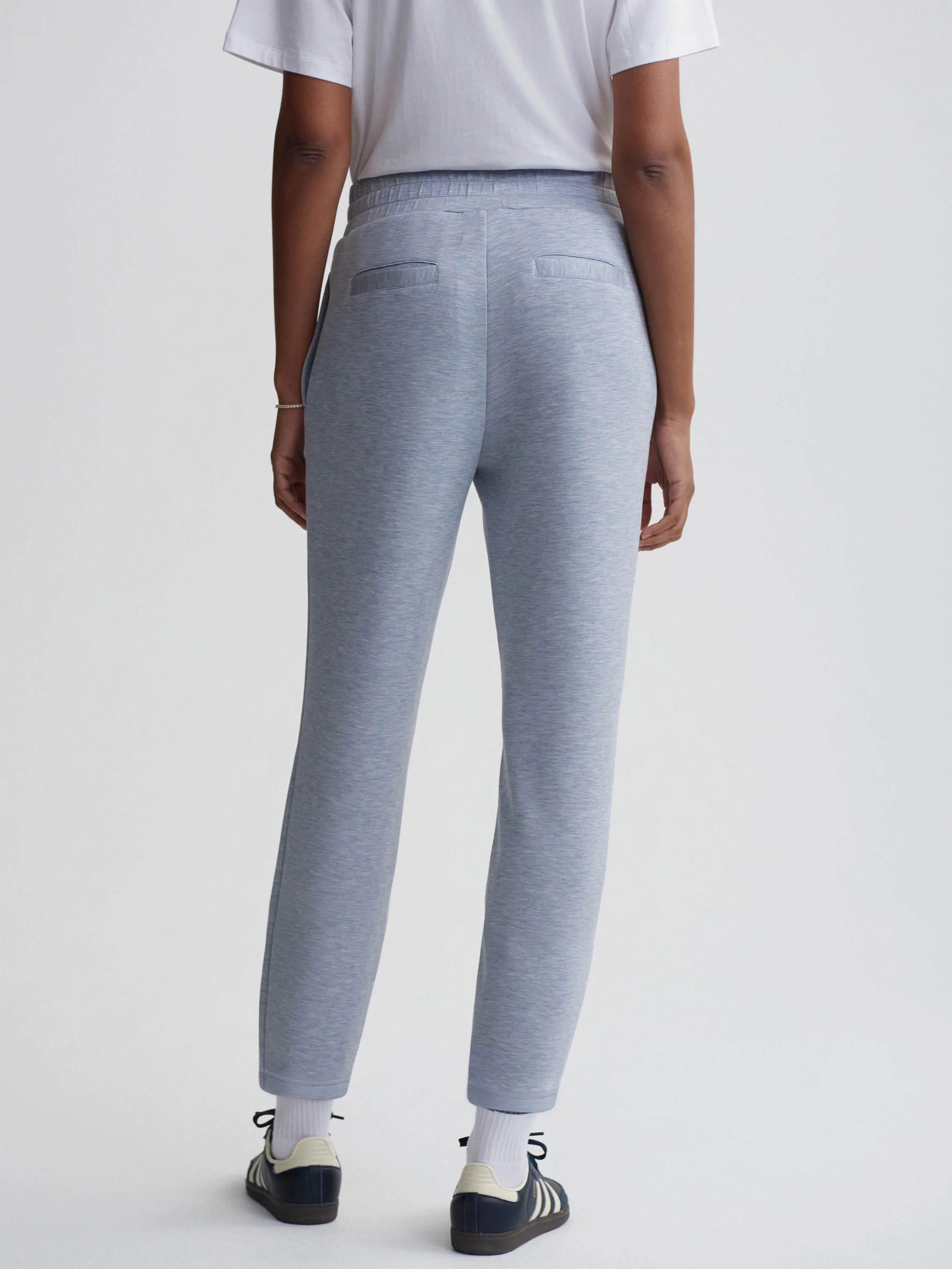 Here's alt text under 125 characters:

"Light blue heather knit slim-fit pants, seen from the back.  Elastic waistband,...