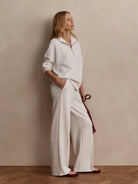 Light heather gray wide-leg pants in a soft knit fabric. Worn by a model to show the full length.