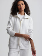 Off-white zip-through jacket with gold zipper and ribbed cuffs.  Features patch pockets.