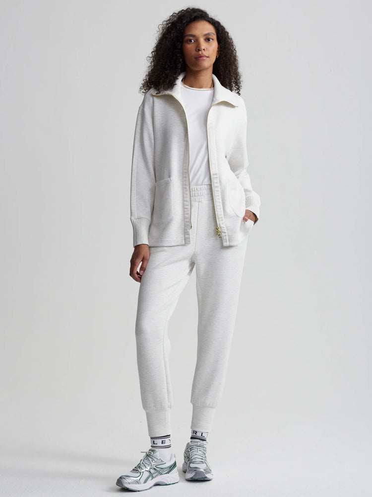 Off-white zip-through jacket with gold zipper.  Features ribbed cuffs and pockets.