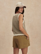 Cream & muted olive sleeveless knit top with a geometric pattern and ribbed trim.