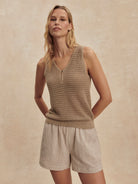 Tan open-knit V-neck tank with a single button henley placket.
