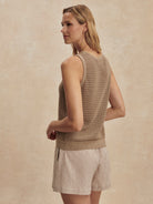 Tan open-knit tank top, sleeveless, with a ribbed hem.