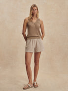Tan knit tank with V-neck, single button closure, and open-weave texture.