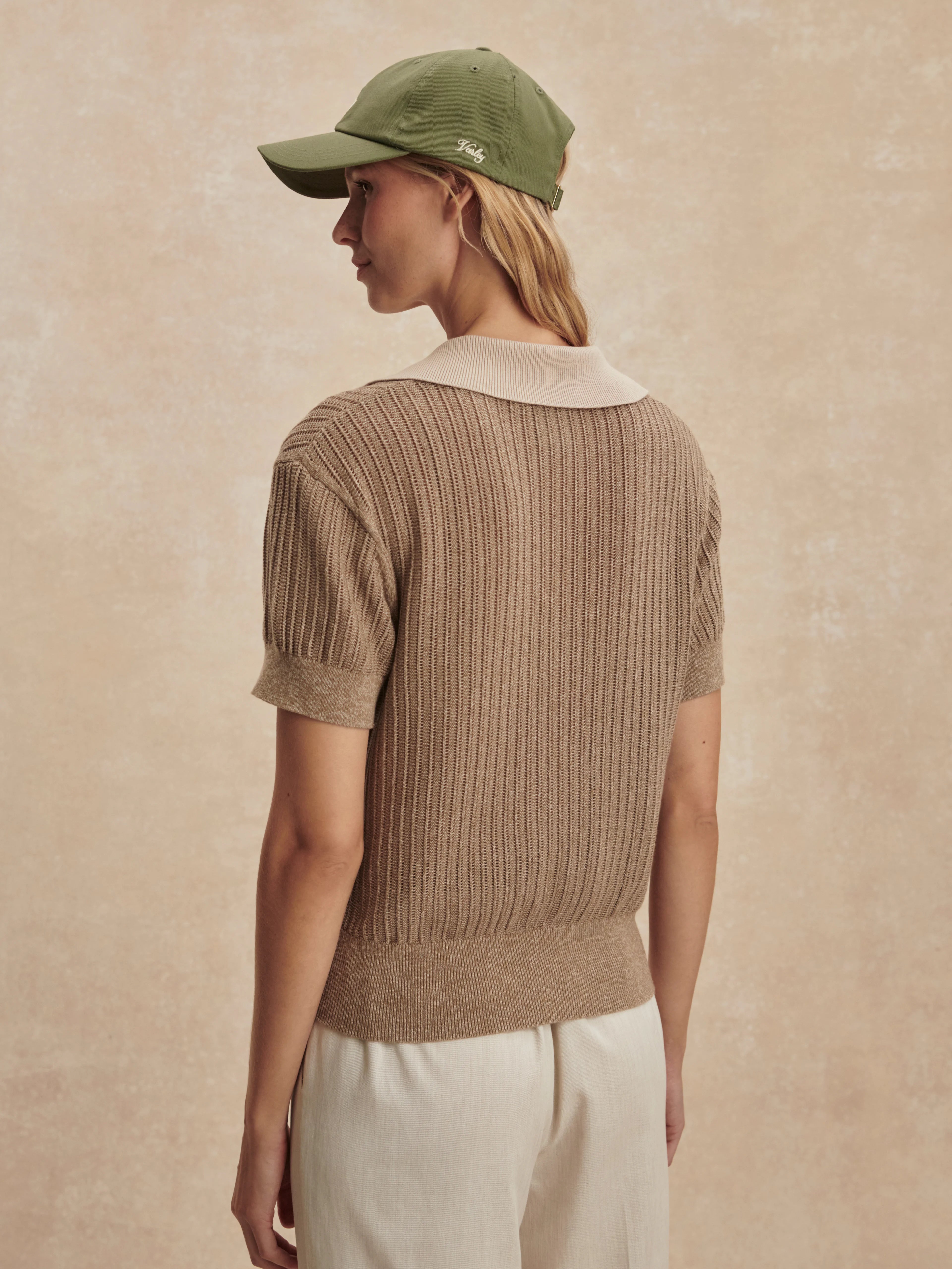 Tan ribbed knit polo with short sleeves & cream collar.