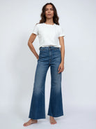 Here's alt text for the image, under 125 characters:

"Image of  high-waisted, medium-wash blue cropped flared jeans. ...