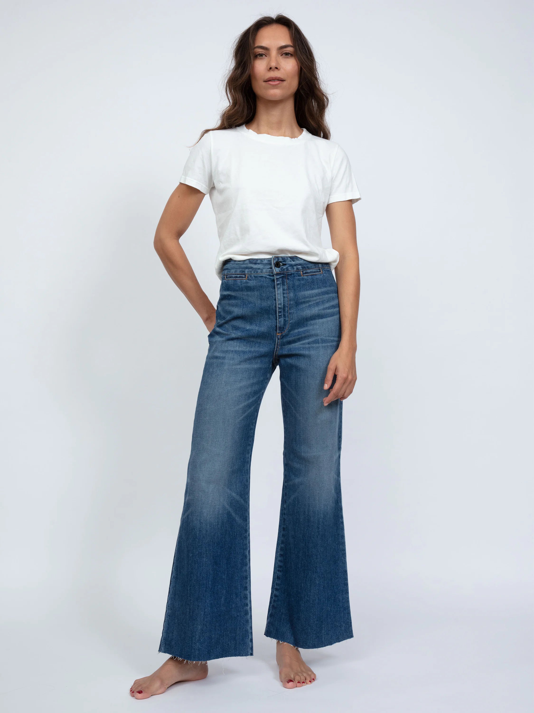 Here's alt text for the image, under 125 characters:

"Image of  high-waisted, medium-wash blue cropped flared jeans. ...