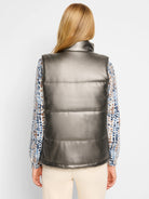 Gunmetal gray puffer vest.  Three horizontal seams. Faux leather.  Shown with a patterned top.