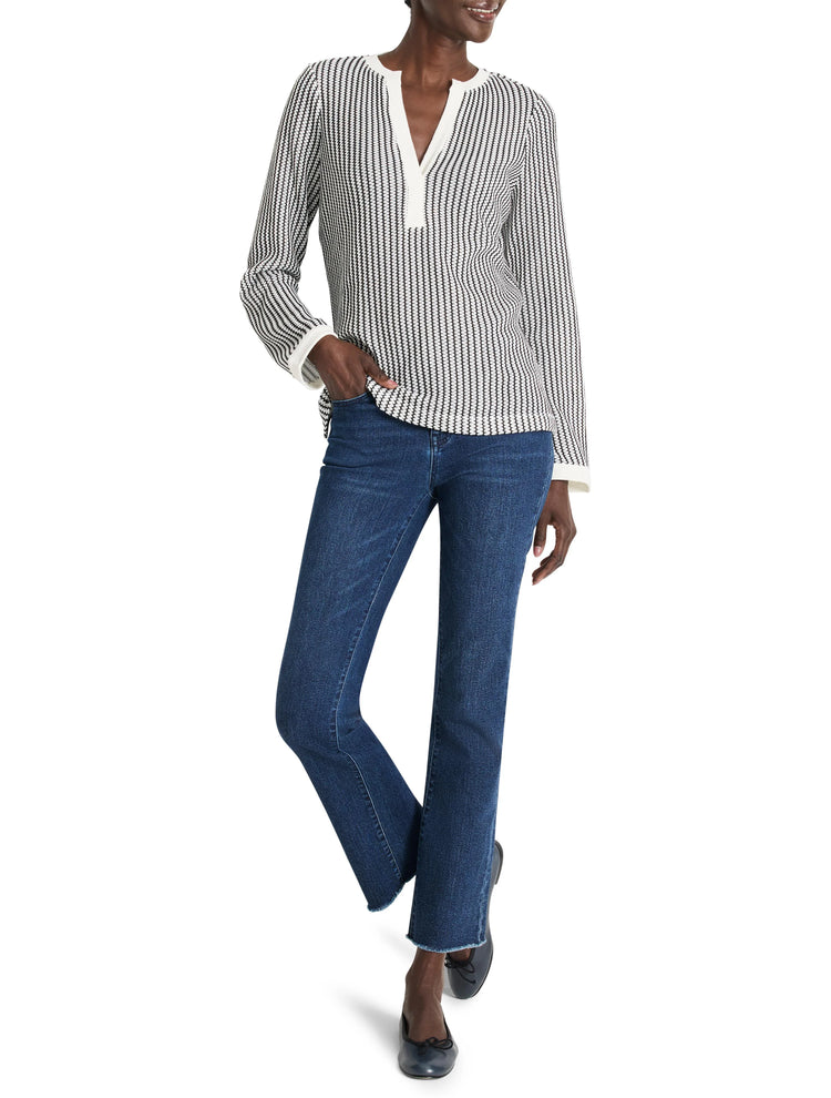 Off-white top with thin black vertical stripes, split neckline.  Long sleeves, and slightly cropped.