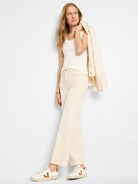 Ivory fine-ribbed scoop neck tank, subtly fitted.