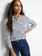 Off-white top with dark blue animal print, cowl neck, three-quarter sleeves.