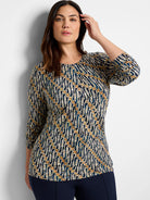 Brown, teal, and cream batik print 3/4 sleeve drape top.  Abstract wavy pattern.