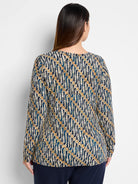 Here's alt text for the image, following your specifications:

"Long-sleeve drape top.  Blue, tan, and white batik...