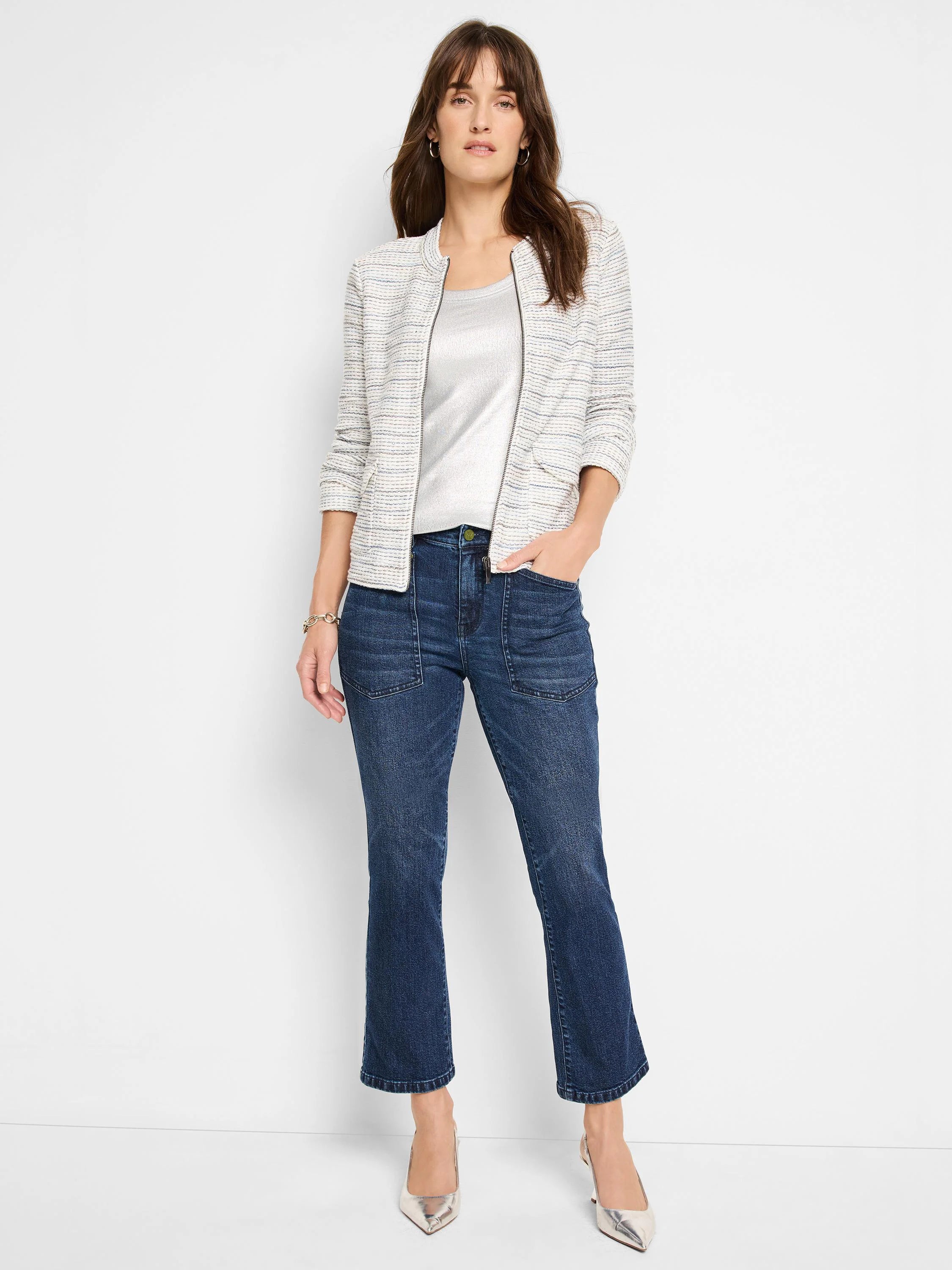 Off-white jacket with thin blue and gray stripes, zipper front, and small pockets.  Model also wears silver top and dark...