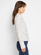Cream-colored knit jacket with thin, horizontal stripes in blue and beige.  Long sleeves, zip front.