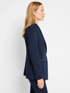 Navy blue zip-front jacket, single button closure, side zip pocket detail.