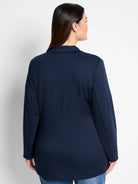 Navy blue zip-up jacket, long sleeves, collared.  Rear view.