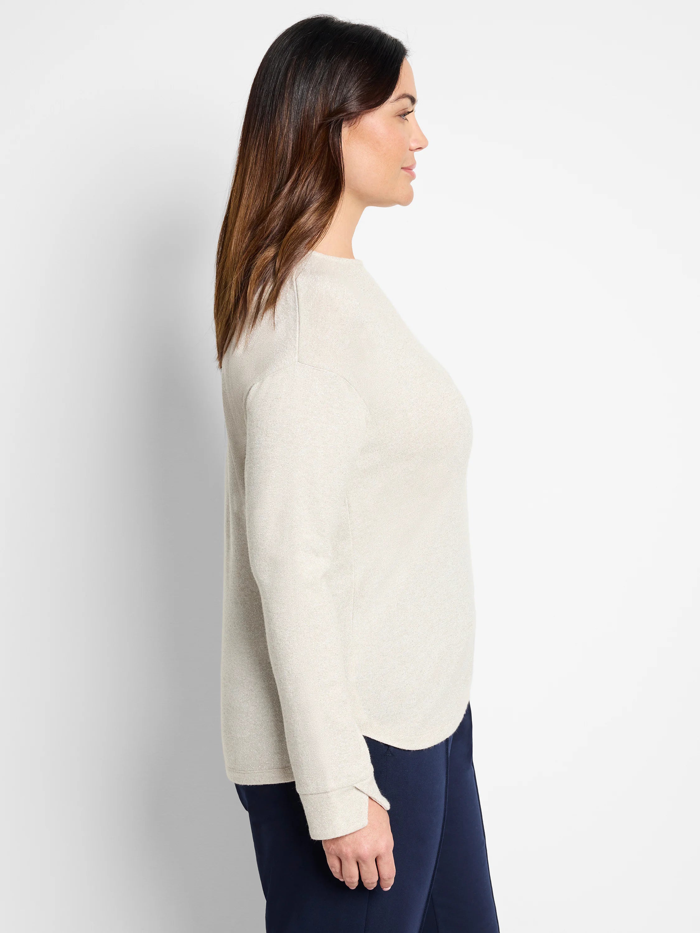 Off-white, long-sleeve top with subtle sparkle.  Shown on model with dark navy pants.