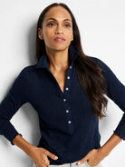 Navy blue textured knit collared top with a Henley button placket, white buttons, and ruffled long sleeve cuffs.