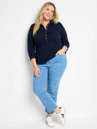 Navy lace knit collared top with white buttons, 3/4 sleeves, and scalloped edges.