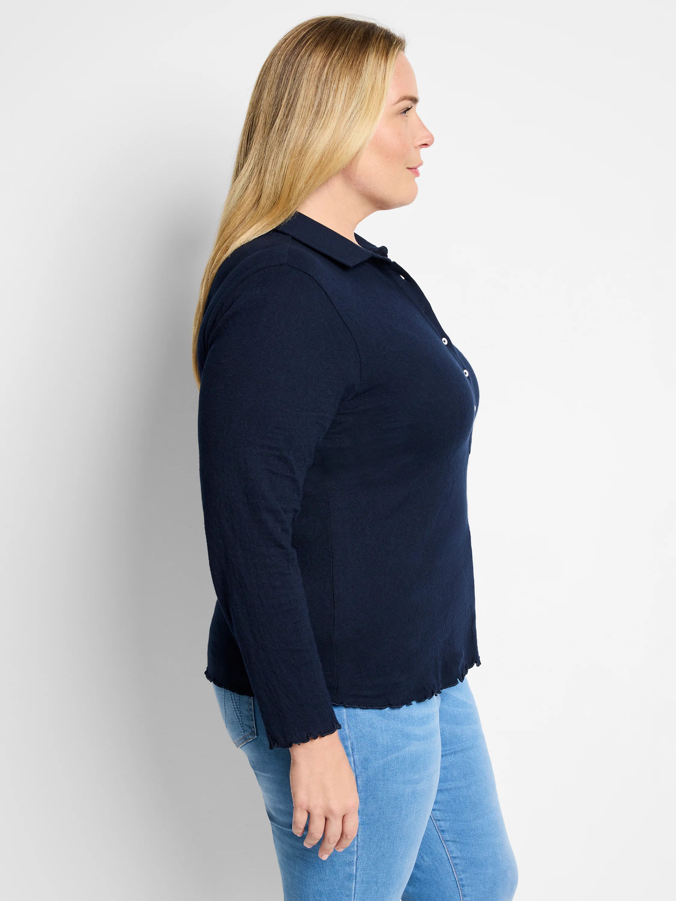 Navy lace knit collared top with long sleeves, white buttons, and ruffled cuffs/hem.