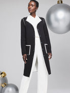 Black long cardigan with white contrast stitching, button front, and pockets.  Reversible.