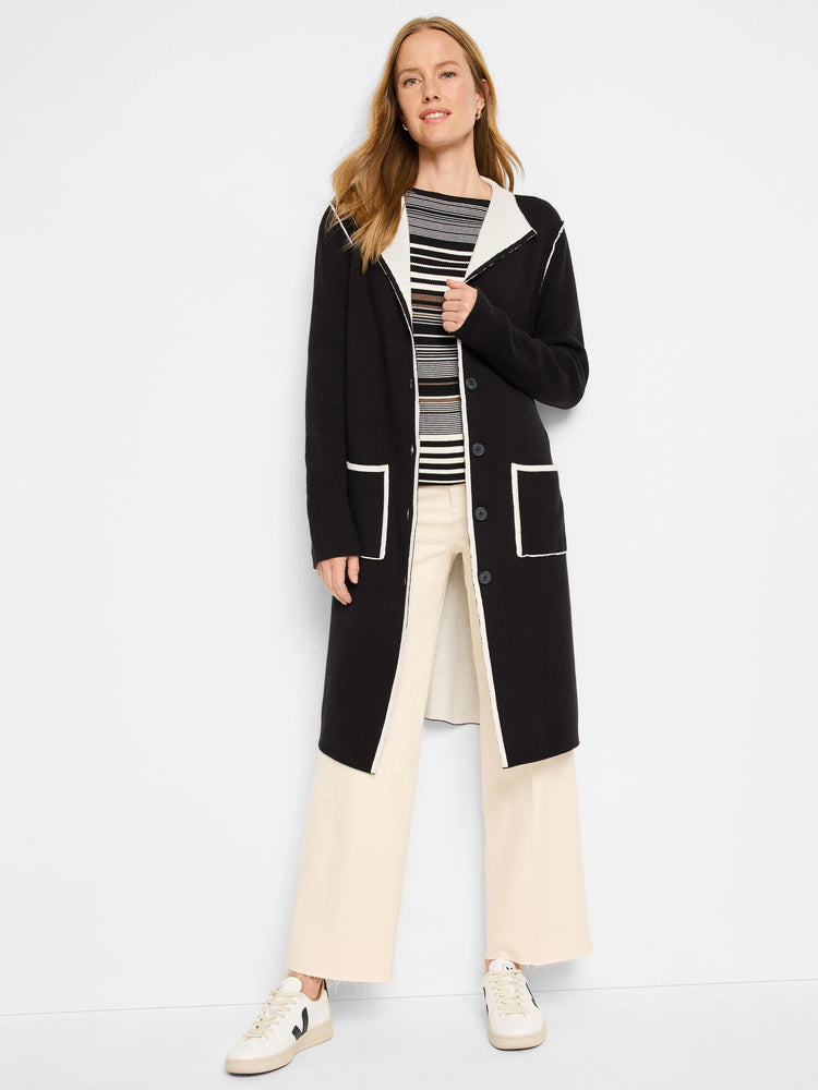 Black, long reversible jacket with off-white trim on lapel, front edge, hem, and two rectangular patch pockets.