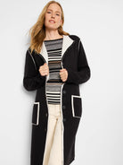 Black reversible jacket with cream trim on lapels, front, and patch pockets. Features dark buttons.