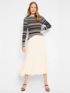 Black, white, and brown striped ribbed sweater tee; long sleeves.  Off-white pleated midi skirt.