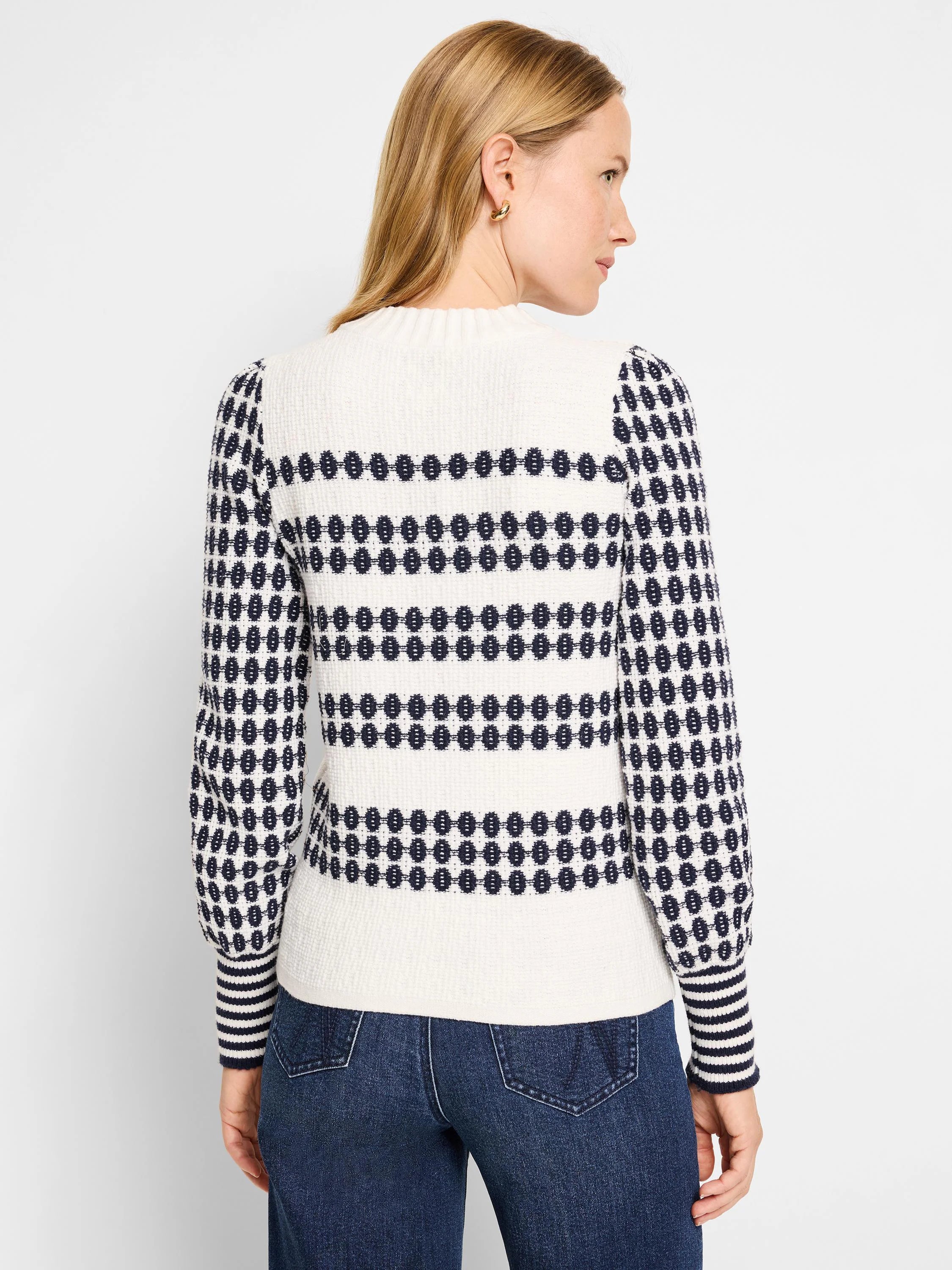 Cream waffle-knit sweater with navy horizontal stripes and pattern.  Puff sleeves and ribbed cuffs.