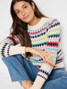 Cream waffle-knit sweater with multicolored horizontal stripes in teal, pink, orange, and lime green.  Features a fair...