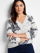 Light gray V-neck sweater with a dark gray camouflage pattern.
