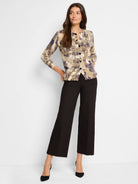 Beige cardigan with purple and taupe abstract print, button front closure.