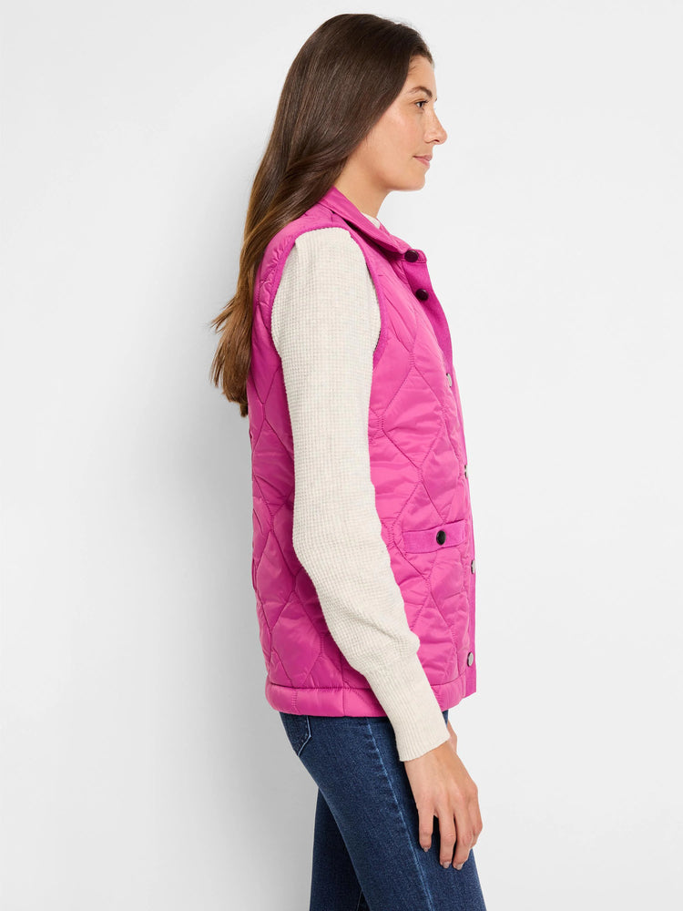 Pink quilted puffer vest with knit trim and dark buttons. Side view.
