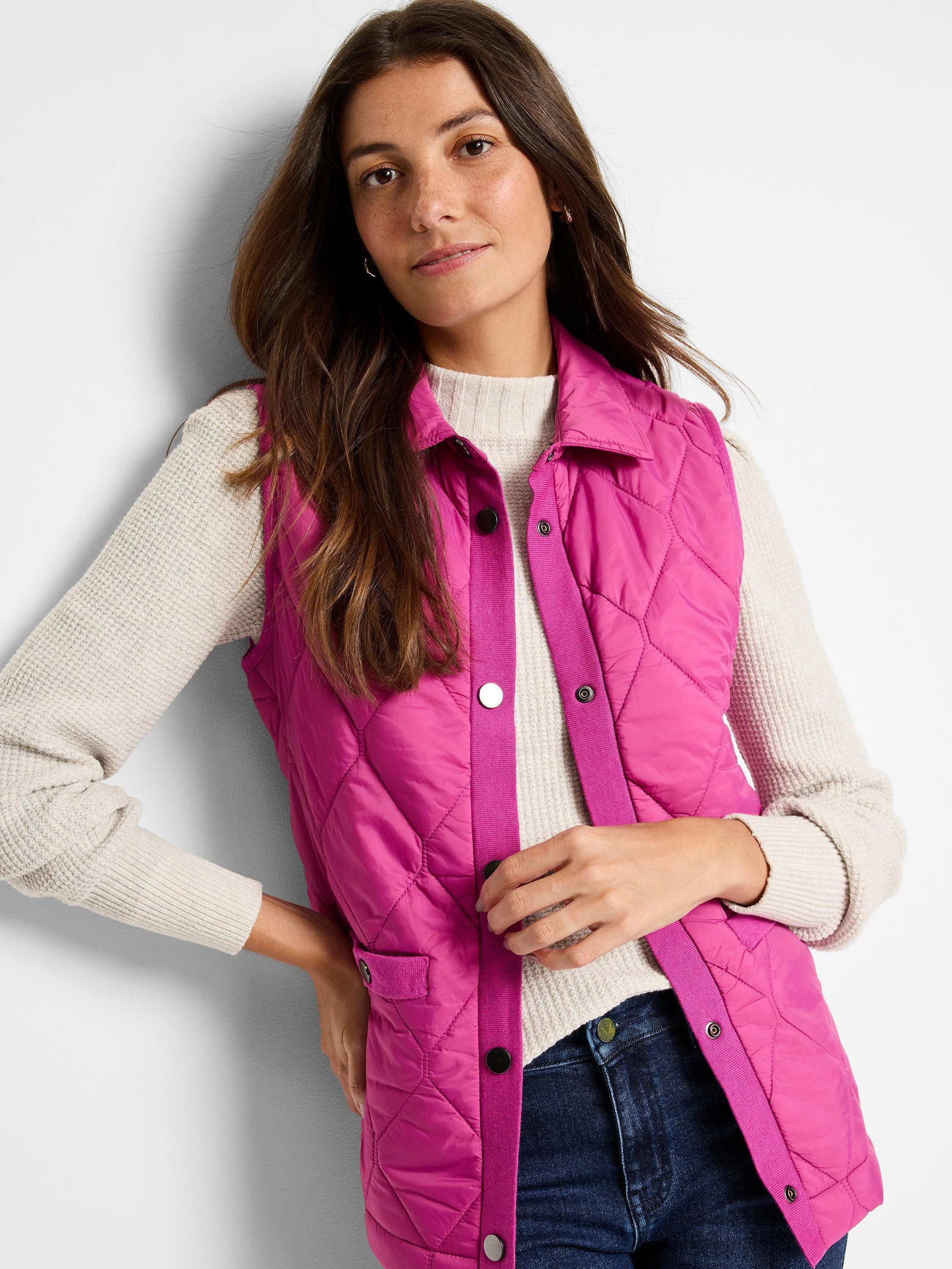 Fuchsia quilted puffer vest with knit trim and dark buttons.  Sleeveless.