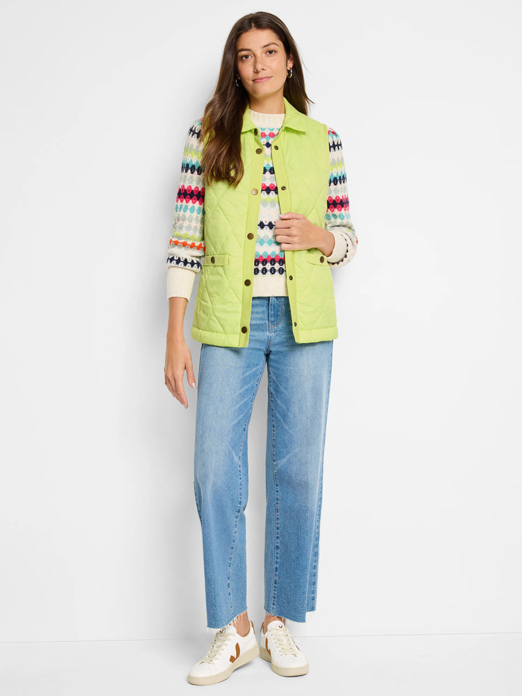 Lime green quilted puffer vest with gold buttons.  Model wears it over a multicolored striped sweater.