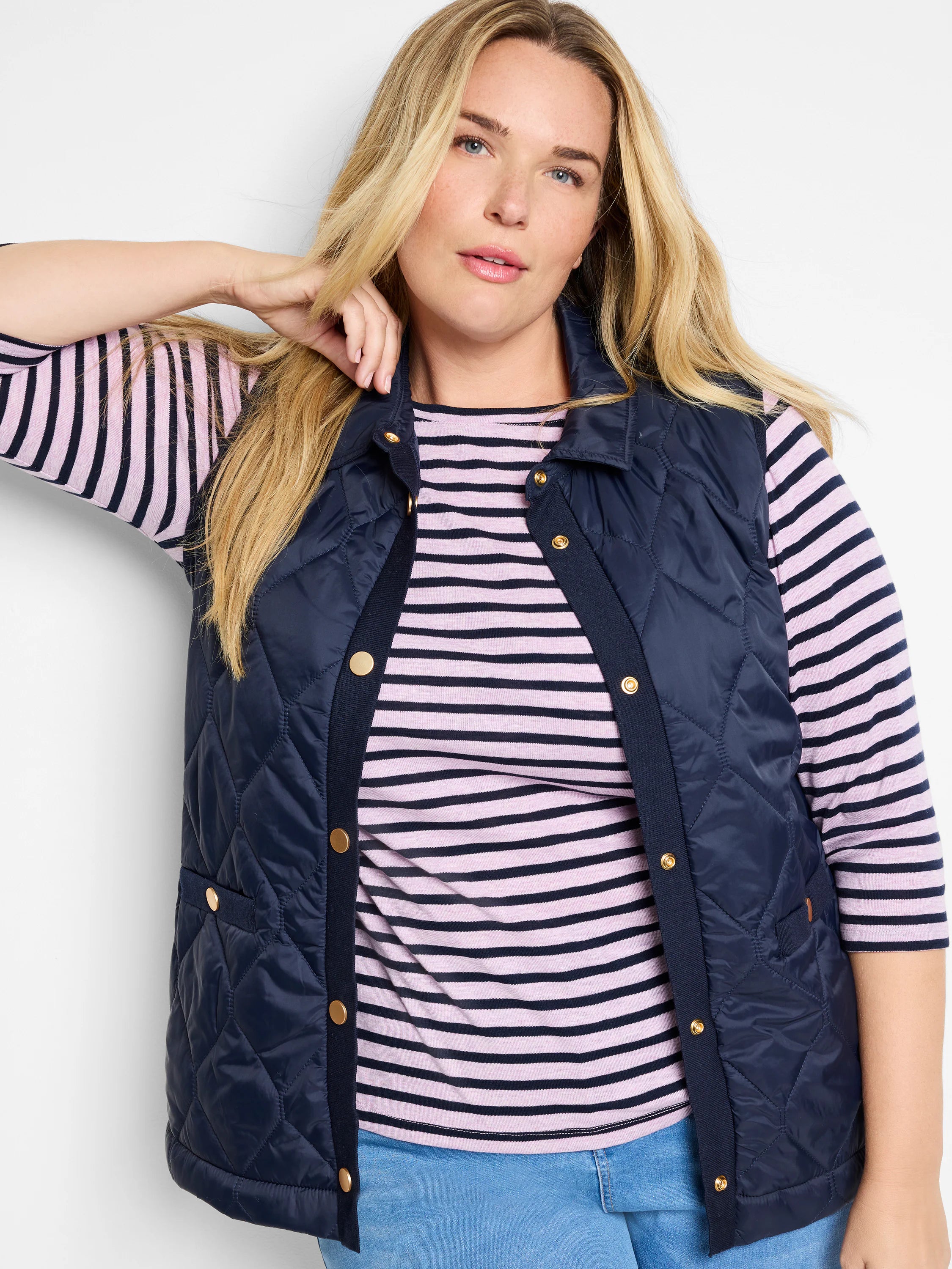 Navy blue quilted puffer vest with gold buttons.  Knit trim detail.