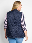 Navy blue quilted puffer vest with diamond pattern.  Back view.