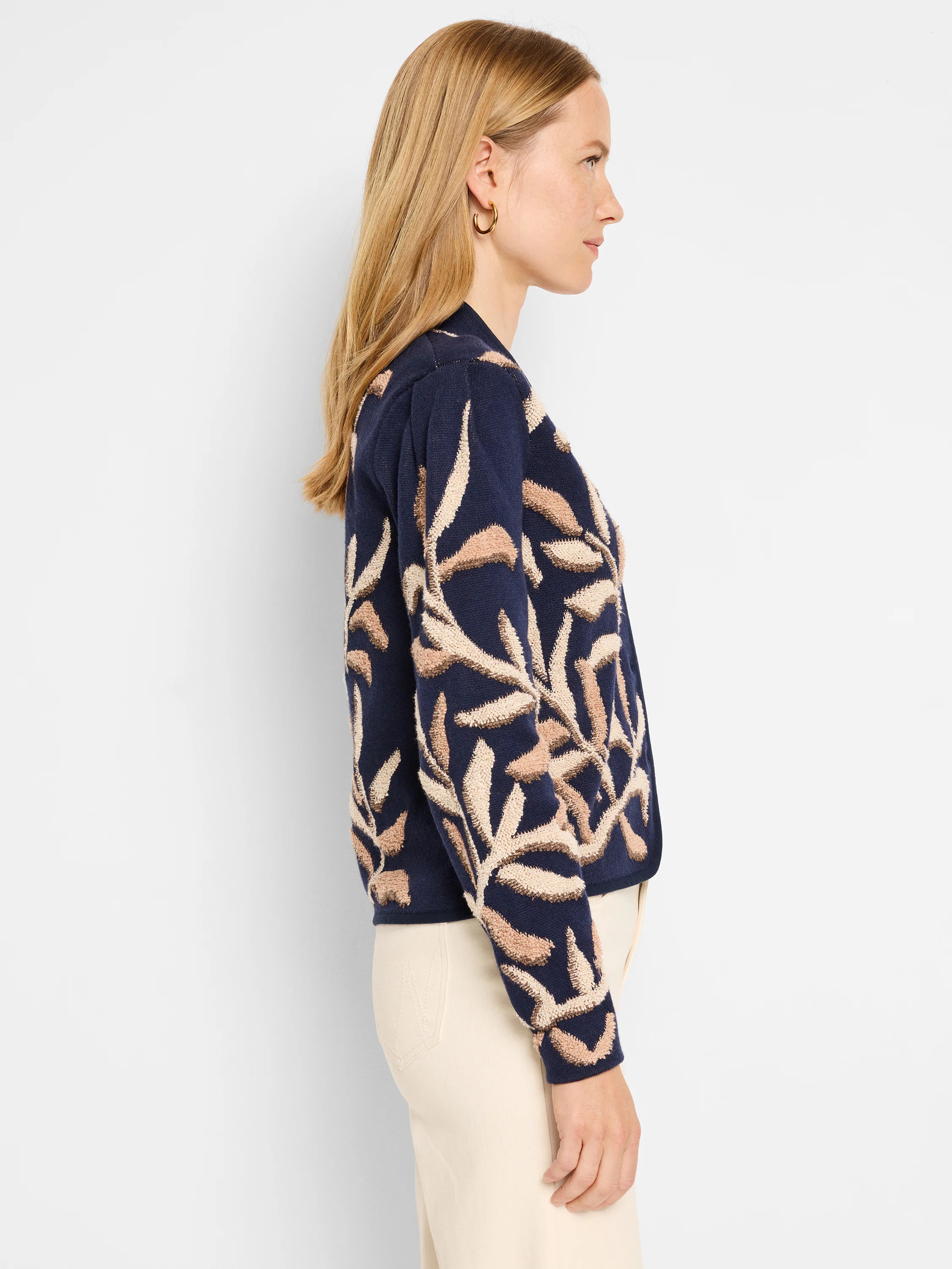 Navy blue knit jacket with beige leaf pattern.  Tufted texture.